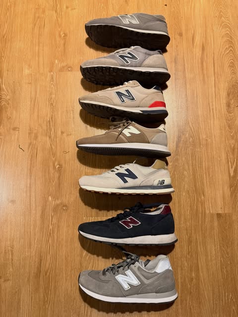 A row of New Balance sneakers in grey, beige, and navy
