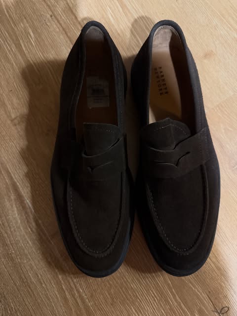 Black suede penny loafers seen from above