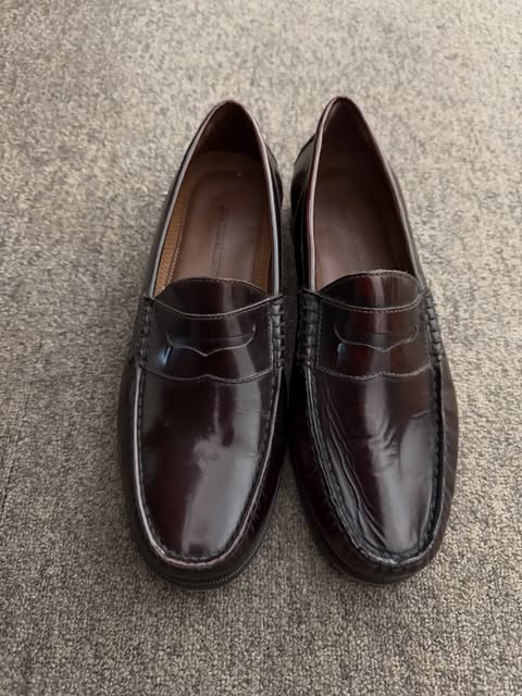 Burgundy leather penny loafers on carpet
